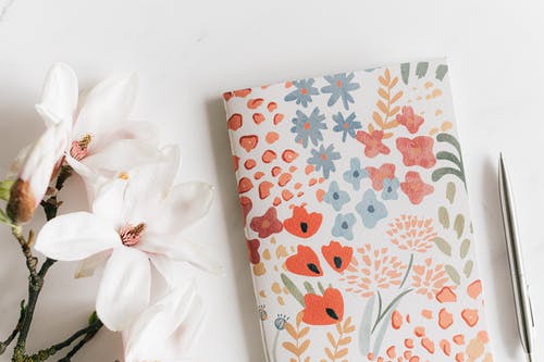 notebook and flowers - used as featured image for post titled "benefits of homeschooling"