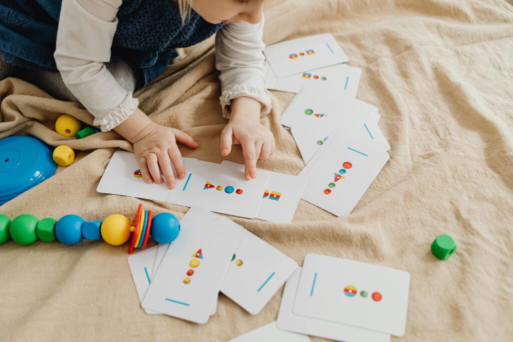 a child playing with educational flashcards