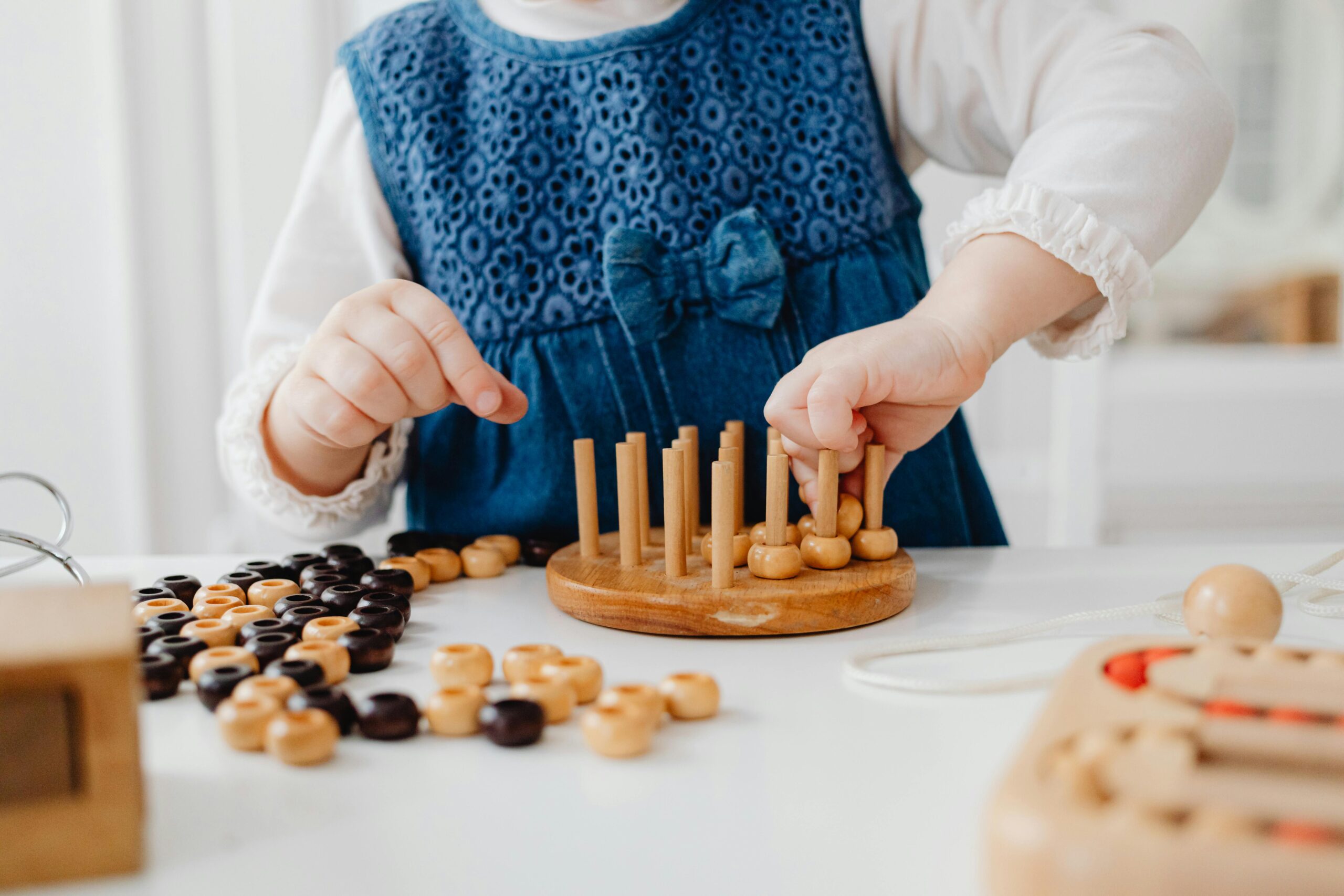 A little girl playing with wooden toys